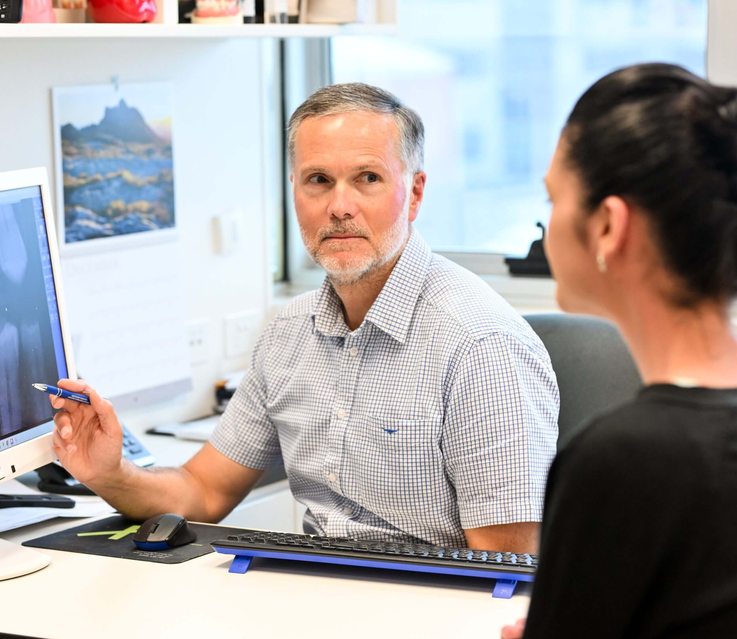 Dr Tony Hill of Tony Hill Dental explaining the treatment to the patient